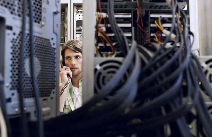 Man in Server Room on Telephone